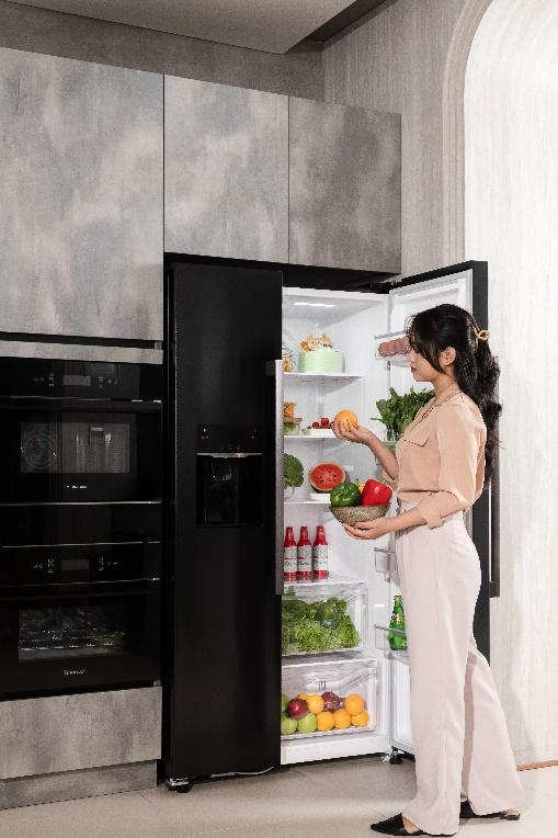 A person standing next to a refrigerator

Description automatically generated with medium confidence